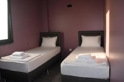 two beds sitting next to each other in a room at maura beach villas family in Kartepe