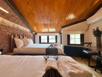 a bedroom with two beds and a wooden ceiling at MorAgop Suites in Istanbul