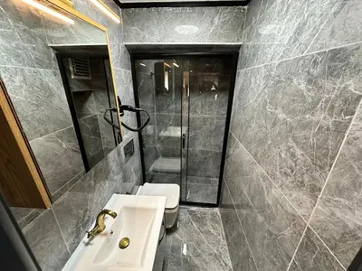 a bathroom with a sink and a shower and a toilet at MorAgop Suites in Istanbul