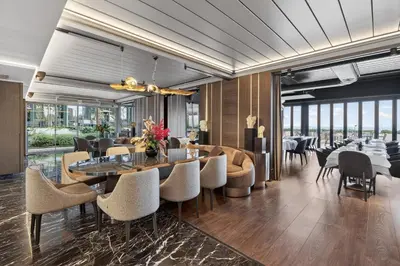 a dining room with tables and chairs and windows at Arbor Hotel - Signature Collection in Istanbul