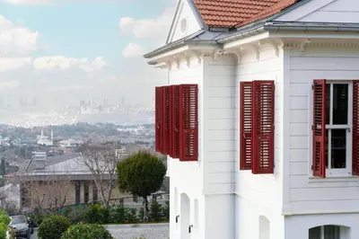 a white house with red shutters on it at Arbor Hotel - Signature Collection in Istanbul