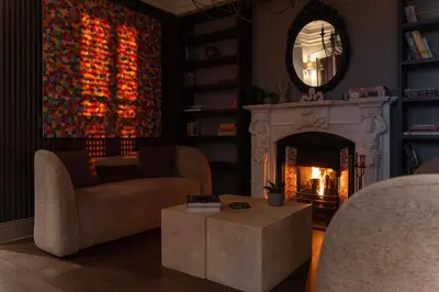 a living room with a fireplace and a mirror at Arbor Hotel - Signature Collection in Istanbul