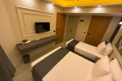 a hotel room with two beds and a television at City Hotel İstanbul in Istanbul