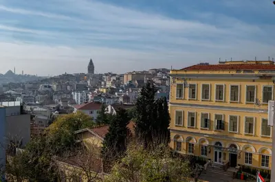 a large yellow building with a city in the background at Bosphorus View - Central Location - 3 Bedrooms in Istanbul