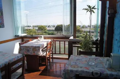 a room with a table and chairs and a balcony at Galley Hotel in Istanbul