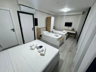 a hotel room with two beds and a tv at QLİNE HOTEL AİRPORT SaW in Istanbul