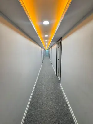 a corridor with an orange ceiling in an office building at QLİNE HOTEL AİRPORT SaW in Istanbul