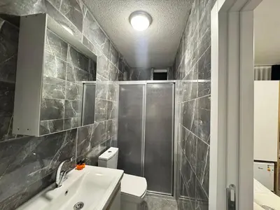 a bathroom with a shower and a sink and a toilet at QLİNE HOTEL AİRPORT SaW in Istanbul