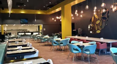 a dining room with tables and blue chairs at The Elysium Styles Taksim in Istanbul