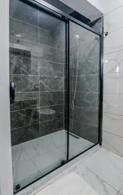 a shower with a glass door in a bathroom at İstanbul Airport Holiday Beach Hotel in Arnavutköy