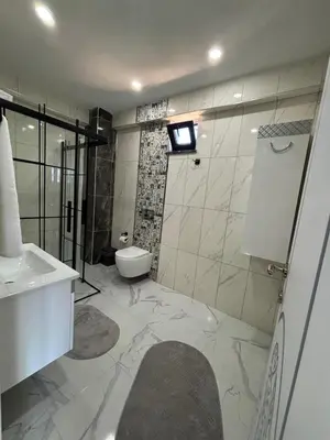 a bathroom with a shower and a toilet and a sink at Villa in nature in Sapanca