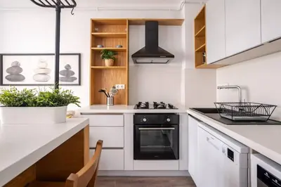 a kitchen with white cabinets and a black oven at Cozy Prime Location 1BD1Bath Sweet Home! #404 in Istanbul