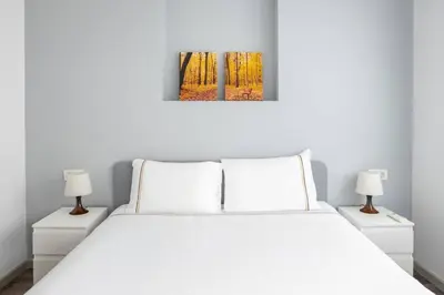 a bedroom with a white bed and two lamps at Cozy Prime Location 1BD1Bath Sweet Home! #404 in Istanbul