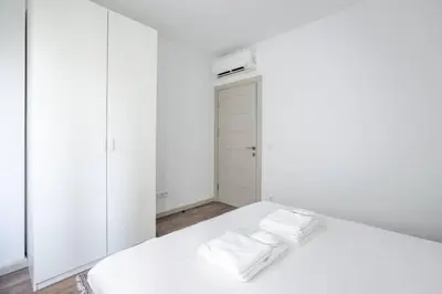 a white bedroom with a bed with towels on it at Cute Intimate Airy 1Bed1Bath Nisantasi Home! #405 in Istanbul