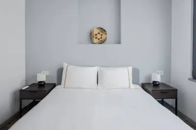 a bedroom with a white bed with two night stands at Cute Intimate Airy 1Bed1Bath Nisantasi Home! #405 in Istanbul