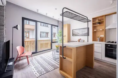 a kitchen with white cabinets and a table and a chair at Cute Intimate Airy 1Bed1Bath Nisantasi Home! #405 in Istanbul