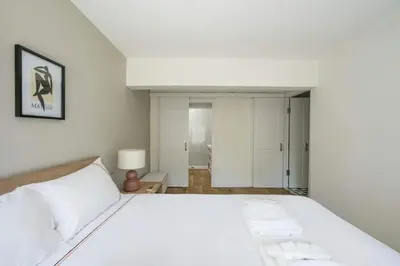 a white bedroom with a large white bed in it at Beautiful Modern Bright 2BD Patio Duplex #179 in Istanbul
