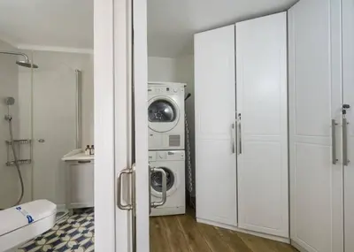 a white laundry room with a washer and dryer at Beautiful Modern Bright 2BD Patio Duplex #179 in Istanbul