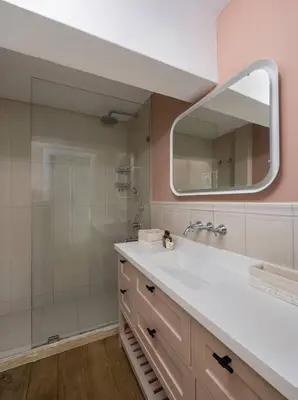 a bathroom with a sink and a shower with a mirror at Beautiful Modern Bright 2BD Patio Duplex #179 in Istanbul