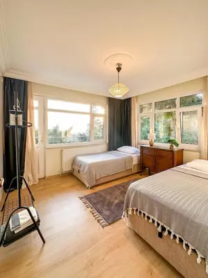 a bedroom with two beds and a window at Cozy 4BR Villa with Lake View and Comfort Galore in Sapanca
