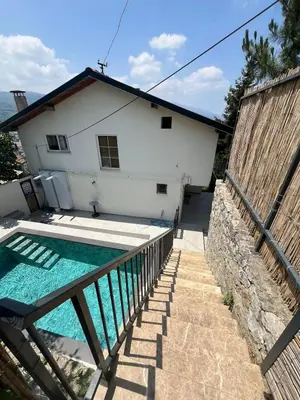 a house with a swimming pool in front of a house at Cozy 4BR Villa with Lake View and Comfort Galore in Sapanca