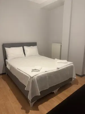 a bed with white sheets and white pillows on it at Disa - Hotel Galata in Istanbul