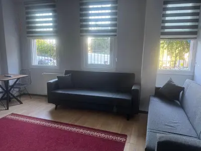 a living room with a couch and two windows at Disa - Hotel Galata in Istanbul