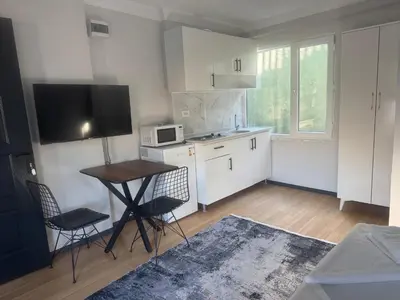 a kitchen with a table and chairs and a microwave at Mehmet Paşa Konağı in Istanbul