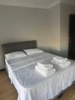 a bed with white sheets and towels on it at Mehmet Paşa Konağı in Istanbul