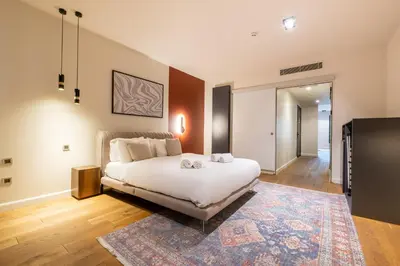 a bedroom with a white bed and a rug at Galata 21 in Istanbul