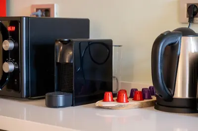 a microwave sitting on a counter next to a coffee maker at Galata 21 in Istanbul