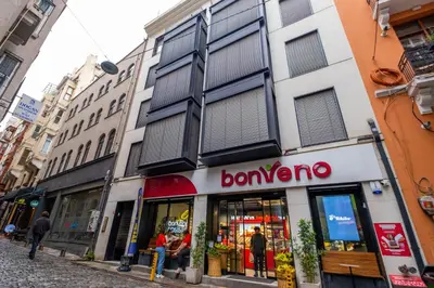 a store on a city street with people standing outside at Galata 21,1 in Istanbul