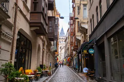 a narrow street with people walking down it at Galata 21,1 in Istanbul