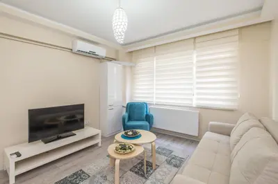 a living room with a couch and a blue chair at White Rose Apart in Istanbul