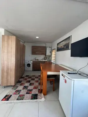 a kitchen with a table and a white refrigerator at Lavina Apartment in Istanbul