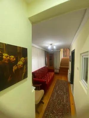 a living room with a red couch and a painting at Muhterem Hanım Konağı in Istanbul