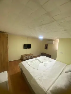 a large white bed in a room with a tv at Muhterem Hanım Konağı in Istanbul