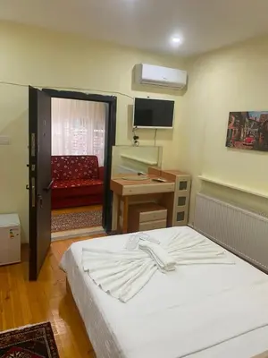 a bedroom with a bed and a desk and a television at Muhterem Hanım Konağı in Istanbul