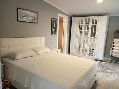 a bedroom with a large white bed and a window at Villa منظر in Sapanca