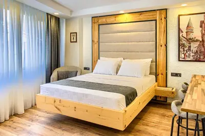 a bedroom with a large bed with a wooden headboard at Vita Otel in Istanbul