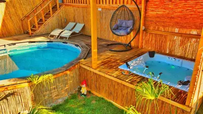 a large swimming pool on a house with a deck at Bambu dağ evi in Sapanca