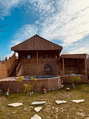 a large wooden house with a pool in front of it at Bambu dağ evi in Sapanca