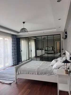 a bedroom with a large bed and a large mirror at Villa Maya Serdivan in Serdivan
