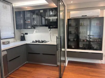 a kitchen with gray cabinets and a counter top at Villa Maya Serdivan in Serdivan