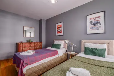 a bedroom with two beds and a mirror at Duplex Flat w Panoramic Bosphorus View and Terrace in Istanbul