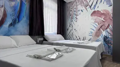 a room with two beds with towels on them at Matrushka Hotel Apart in Istanbul