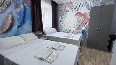 a room with two beds with plates and napkins on them at Matrushka Hotel Apart in Istanbul