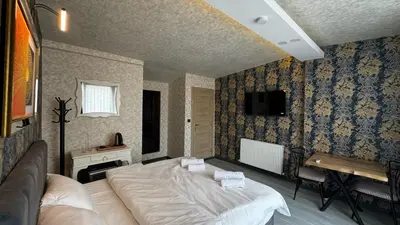 a bedroom with a large white bed in a room at Tuzla Sahil Enjoy Hotel in Tuzla