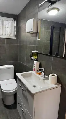 a bathroom with a white sink and a toilet at Tuzla Sahil Enjoy Hotel in Tuzla