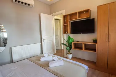 a bedroom with a bed and a flat screen tv at Modern 2BR Flat 1min walk to Taksim square in Istanbul